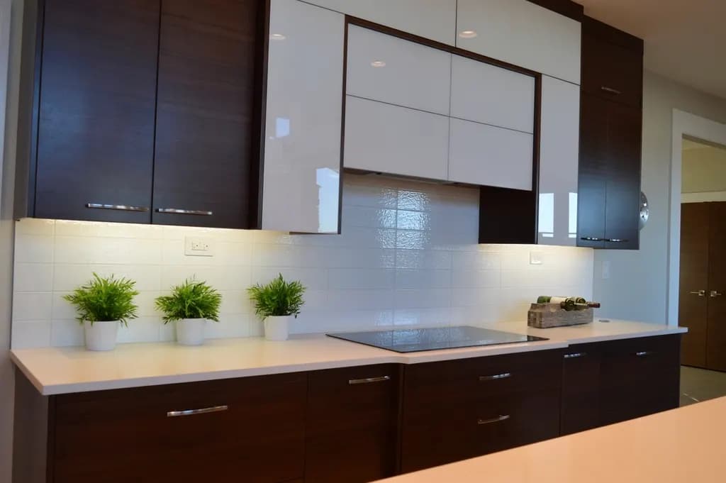 Modular kitchen with dark lower cabinets and white wall cabinets